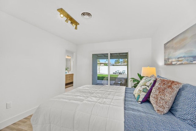 bedroom featuring light hardwood / wood-style flooring and access to outside