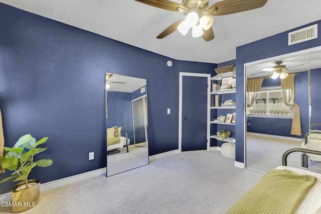 carpeted bedroom with ceiling fan and a closet