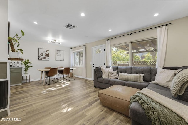 living room featuring a wealth of natural light and light wood-type flooring