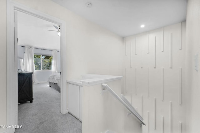 hallway featuring light colored carpet