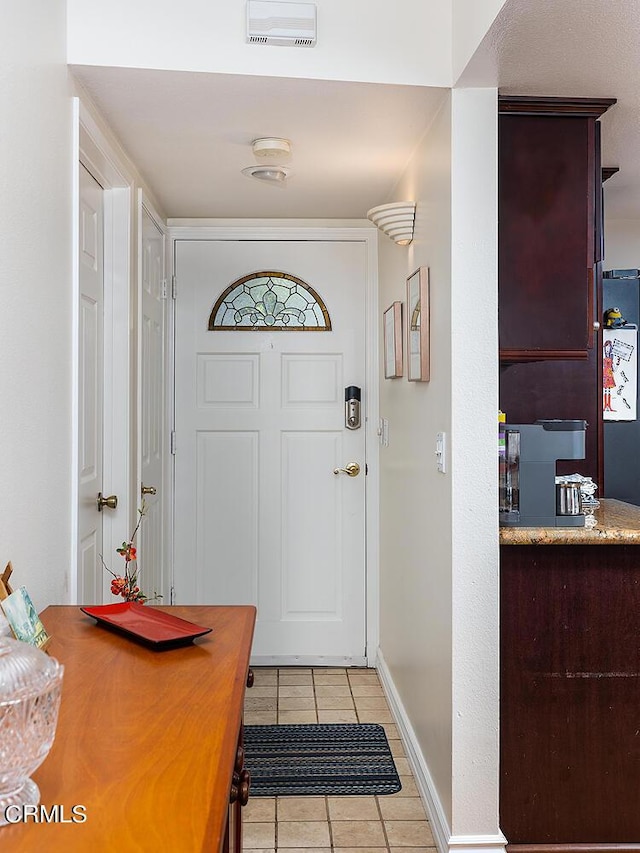 entryway featuring light tile patterned floors