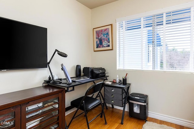 office area with plenty of natural light and light hardwood / wood-style floors