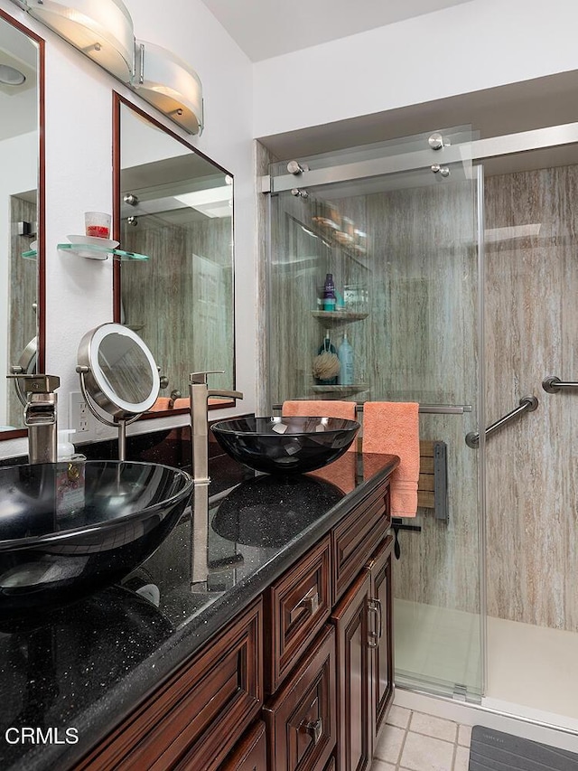 bathroom with an enclosed shower, vanity, and tile patterned floors