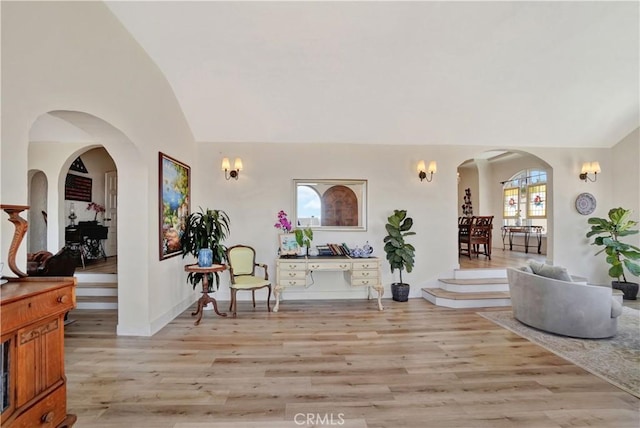 interior space with vaulted ceiling and light hardwood / wood-style flooring