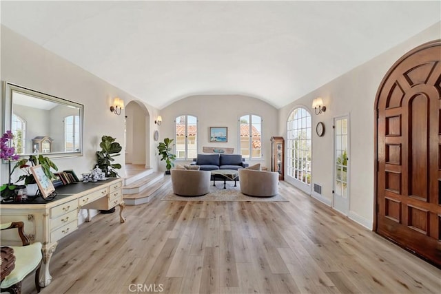 entryway with vaulted ceiling and light wood-type flooring