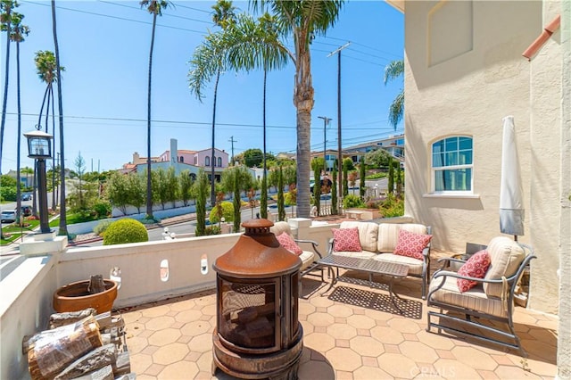 view of patio / terrace with an outdoor living space with a fire pit