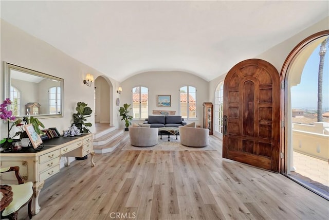 entrance foyer featuring lofted ceiling and light hardwood / wood-style flooring