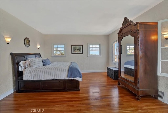 bedroom featuring multiple windows and hardwood / wood-style flooring