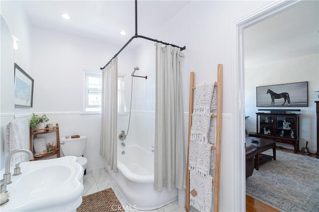 full bathroom with toilet, shower / bathtub combination with curtain, and sink