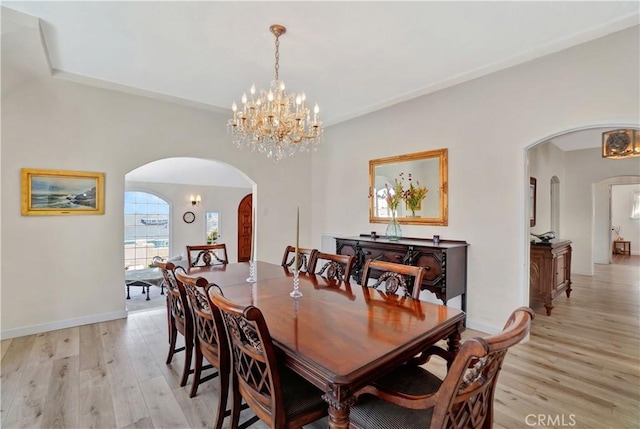 dining room with a chandelier and light hardwood / wood-style floors