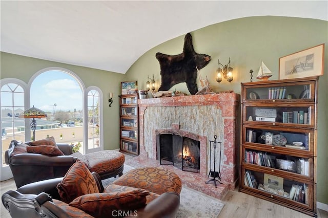 living room featuring vaulted ceiling and light hardwood / wood-style flooring