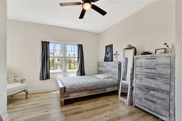 bedroom with ceiling fan and light hardwood / wood-style floors