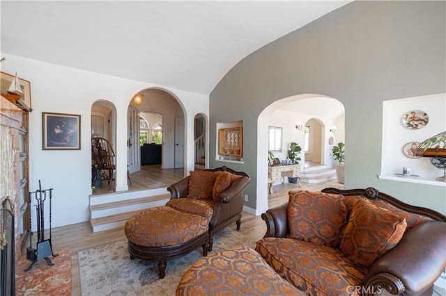 living room featuring vaulted ceiling and light hardwood / wood-style floors