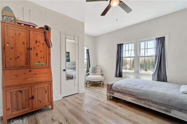 bedroom featuring ceiling fan and light hardwood / wood-style floors