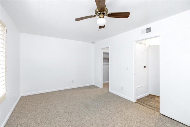 unfurnished bedroom with visible vents, baseboards, ceiling fan, carpet, and a closet