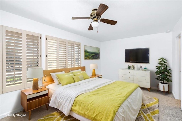 bedroom with carpet, multiple windows, and a ceiling fan