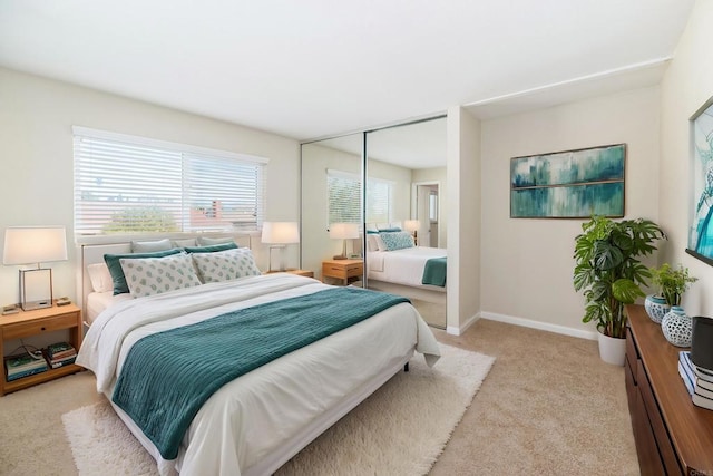 bedroom featuring light carpet and a closet