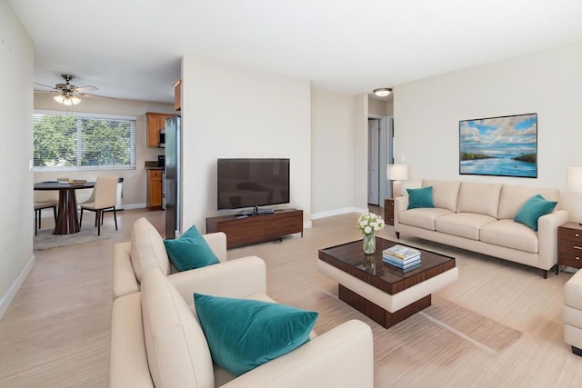 living room with ceiling fan and light hardwood / wood-style floors