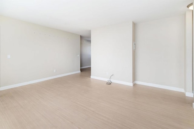 spare room featuring light wood-type flooring