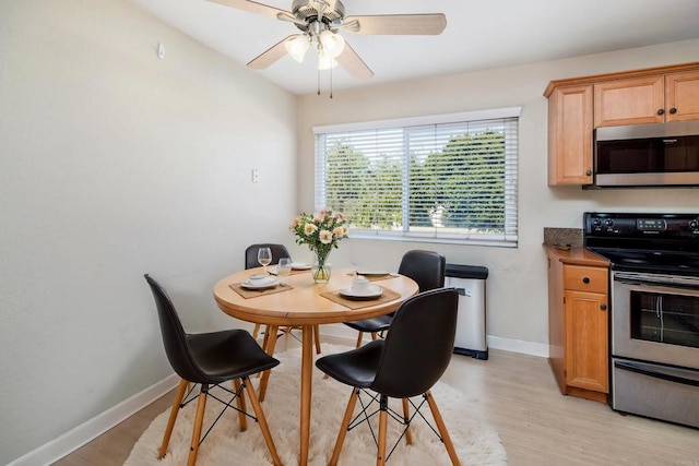 dining space with ceiling fan and light wood-type flooring