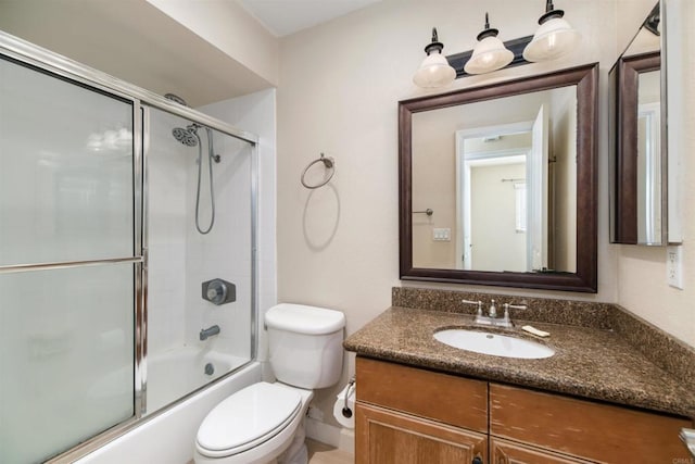 full bathroom with vanity, shower / bath combination with glass door, and toilet