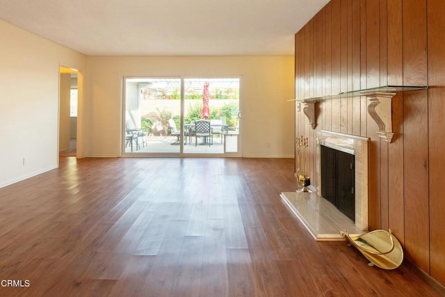 unfurnished living room featuring a high end fireplace and hardwood / wood-style floors