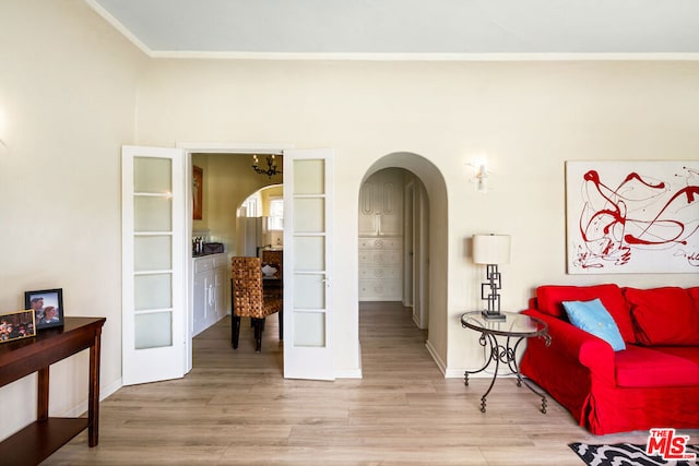 living area featuring light hardwood / wood-style floors and french doors