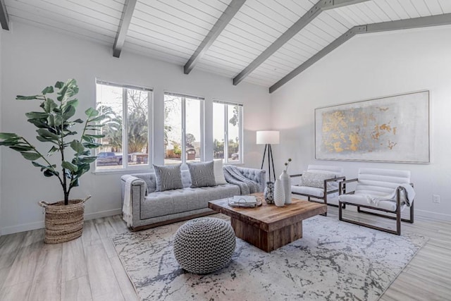 living room with light hardwood / wood-style flooring and lofted ceiling with beams