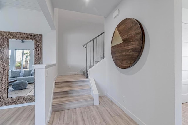 stairway with hardwood / wood-style floors