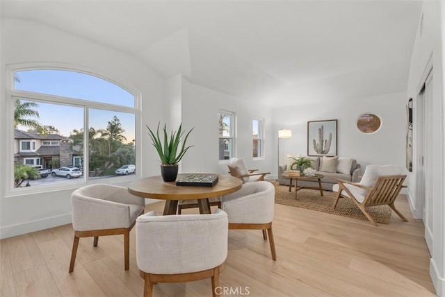 dining area with plenty of natural light and light hardwood / wood-style flooring