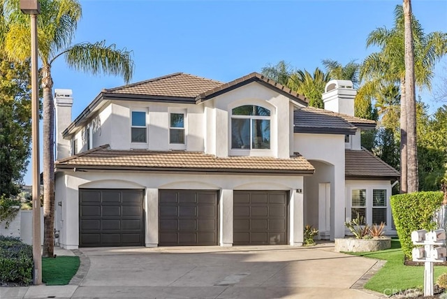 mediterranean / spanish home featuring a garage