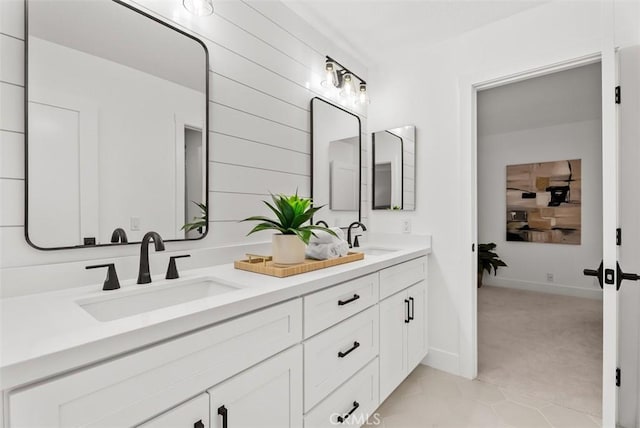 bathroom with vanity, tile patterned flooring, and wood walls