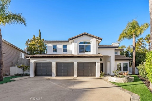 mediterranean / spanish house with a garage