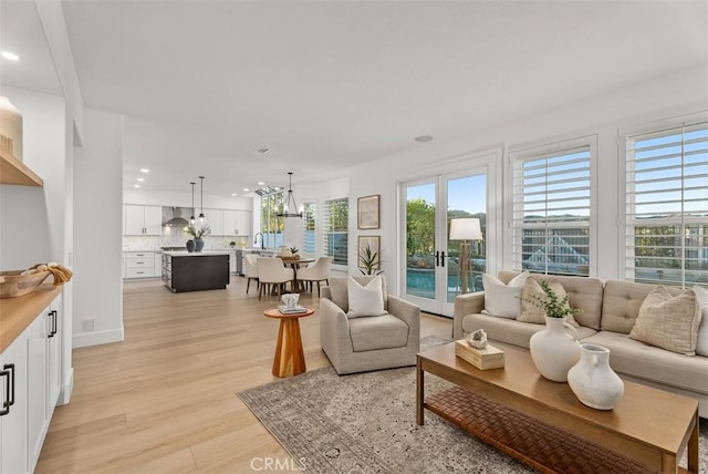 living room featuring light hardwood / wood-style floors and french doors