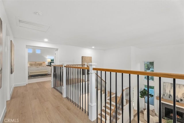 hallway with light hardwood / wood-style flooring