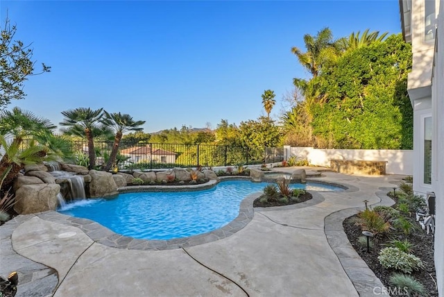 view of pool with a patio and pool water feature