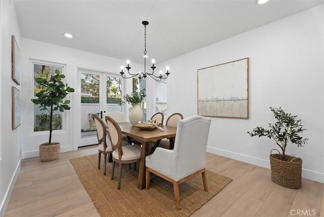 dining room with an inviting chandelier and light hardwood / wood-style floors