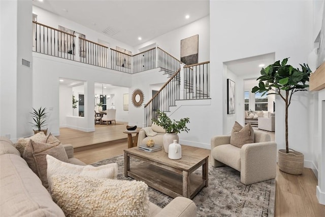 living room featuring wood-type flooring and a high ceiling