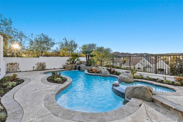 view of pool featuring pool water feature and a patio