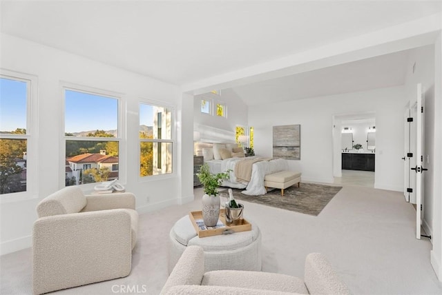 carpeted living room featuring vaulted ceiling