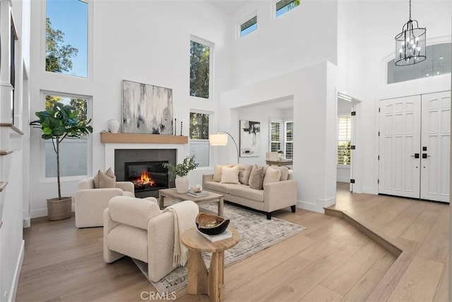 living room with an inviting chandelier and light hardwood / wood-style floors