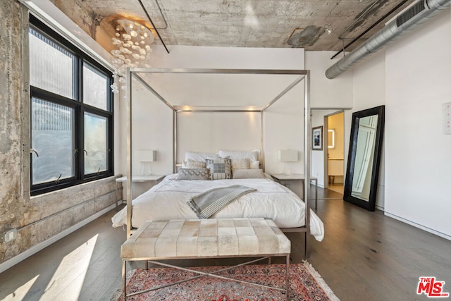 bedroom with dark wood-type flooring