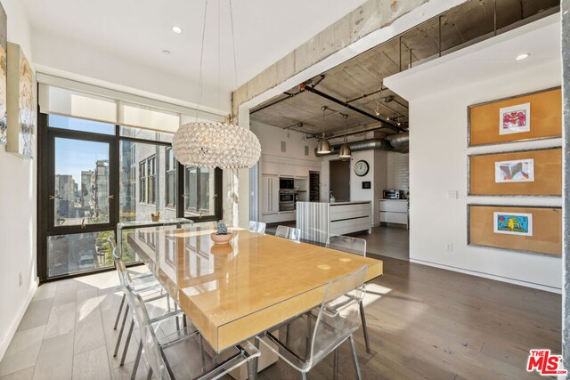 dining space with wood-type flooring