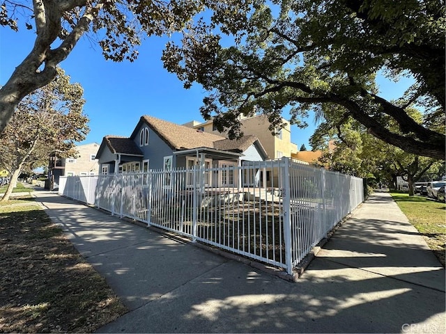 view of front facade featuring a fenced front yard and stucco siding