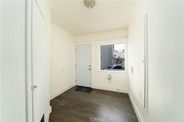 hallway with baseboards and dark wood finished floors