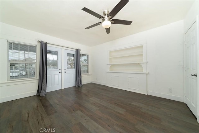 interior space featuring built in features, baseboards, dark wood-type flooring, and a wealth of natural light