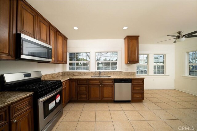 kitchen featuring stainless steel appliances, a wealth of natural light, a sink, and recessed lighting