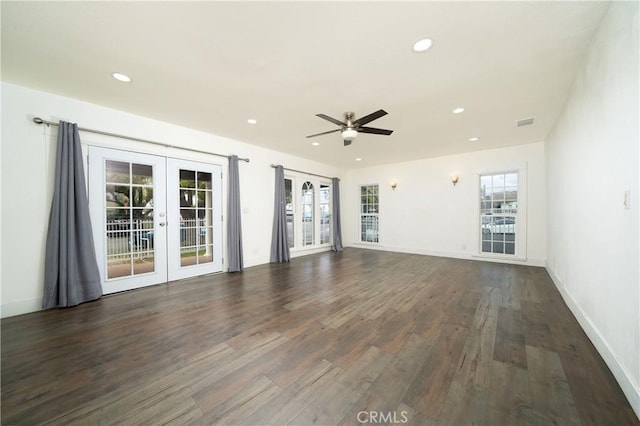 unfurnished living room with dark wood-type flooring, recessed lighting, french doors, and baseboards