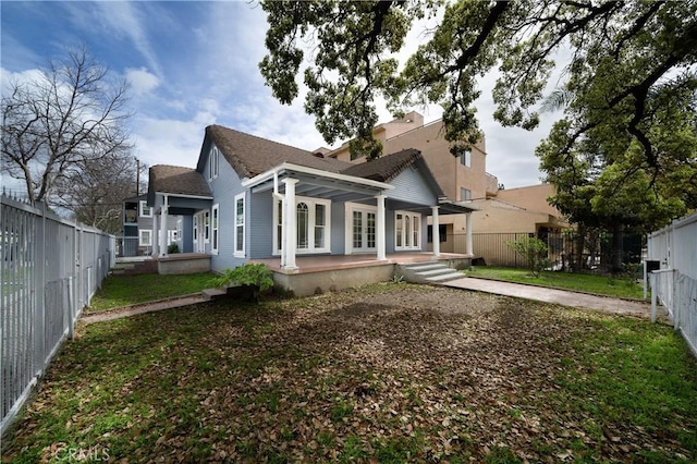 back of house with french doors and a fenced backyard