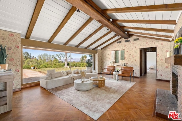 living room featuring parquet flooring, a fireplace, and vaulted ceiling with beams